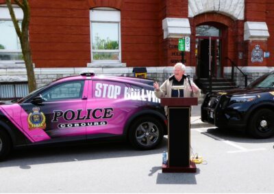 Cobourg Police Chief Paul VandeGraaf and Chapter Lead David Kuhnke introducing the new Mustang Mach e to the police services fleet as community outreach vehicle