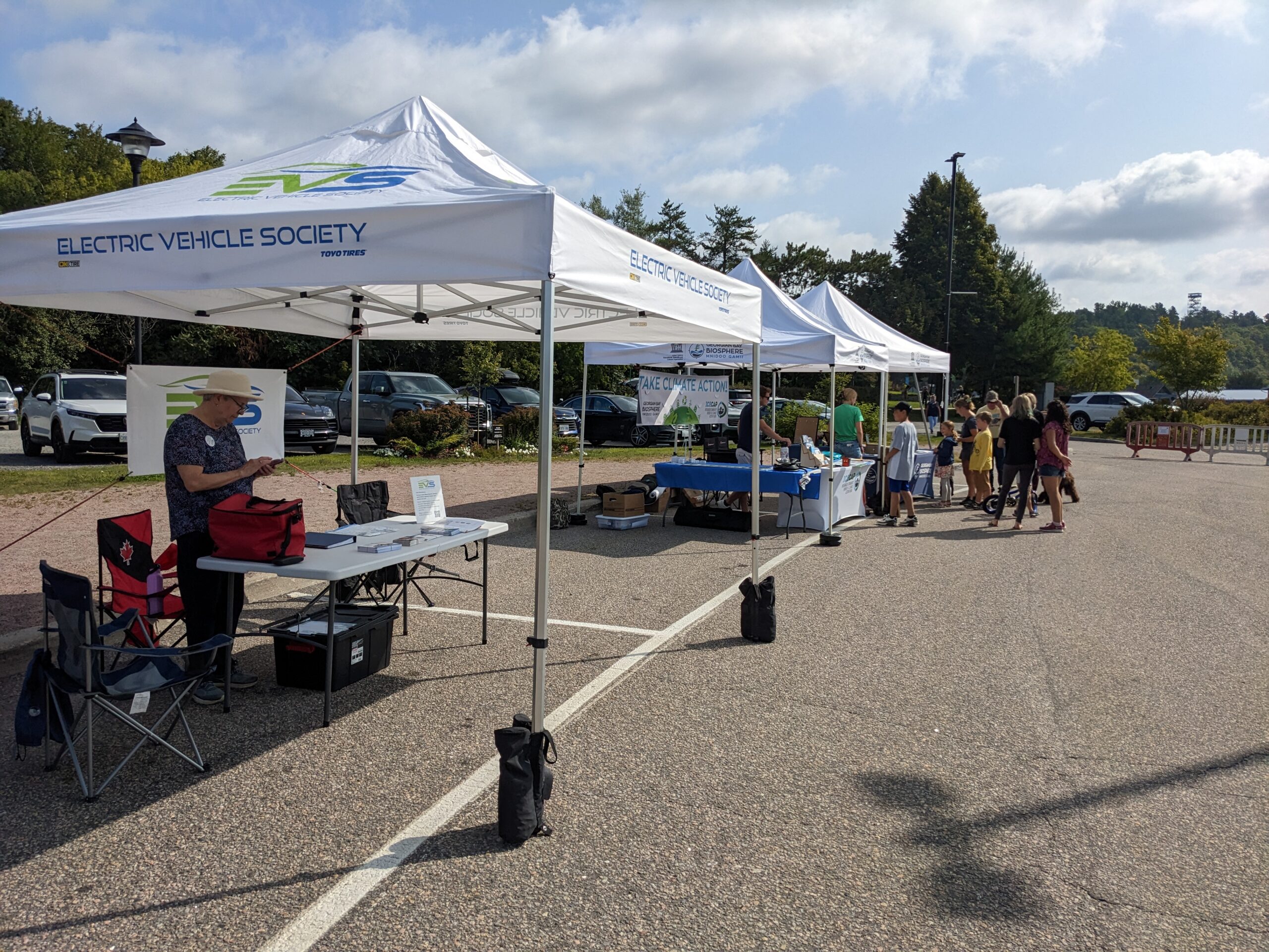 Outdoor EV Awareness event with EV Society tents and information table